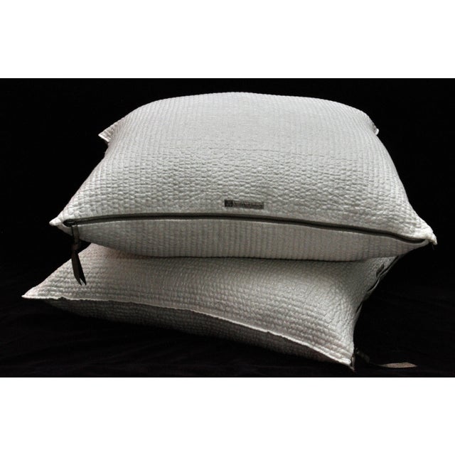 Pair of Maison de Vacances Parisian creme pillows. Made from washed linen, and designed with a zipper and leather pull tag...