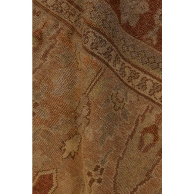 A late 19th century Indian Amritsar rug, the camel field with an allover trellis design of palmettes, cypresses and...