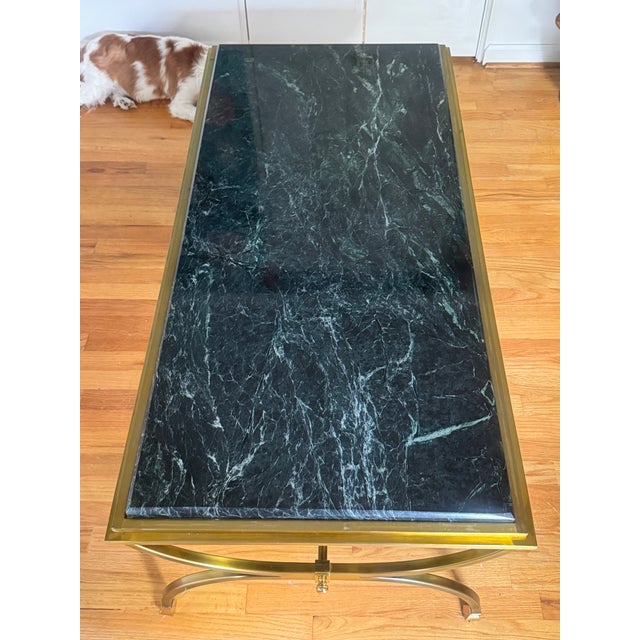Listing is for a Maison Jansen Neoclassical style brass conjoined oval coffee table base with inset green marble top. No...