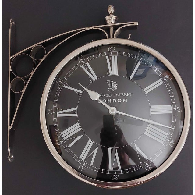 Offered here is a two-sided Regent Street London train station clock made by Eichholtz. The Dutch luxury brand Eichholtz...