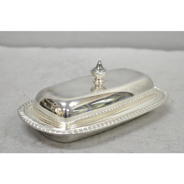 Vintage Oneida Silver Plated Covered Butter Dish w/ Glass Liner (B). Circa Mid 20th Century. Measurements: 3" H x 7.5" W x...