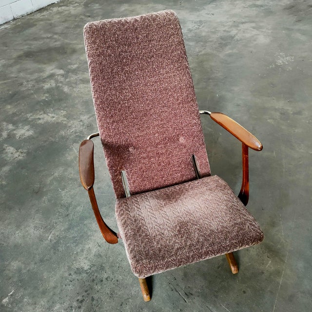 Armchair made in Germany in the 1950s, with a steel frame and light brown fabric upholstery. The seat is height...