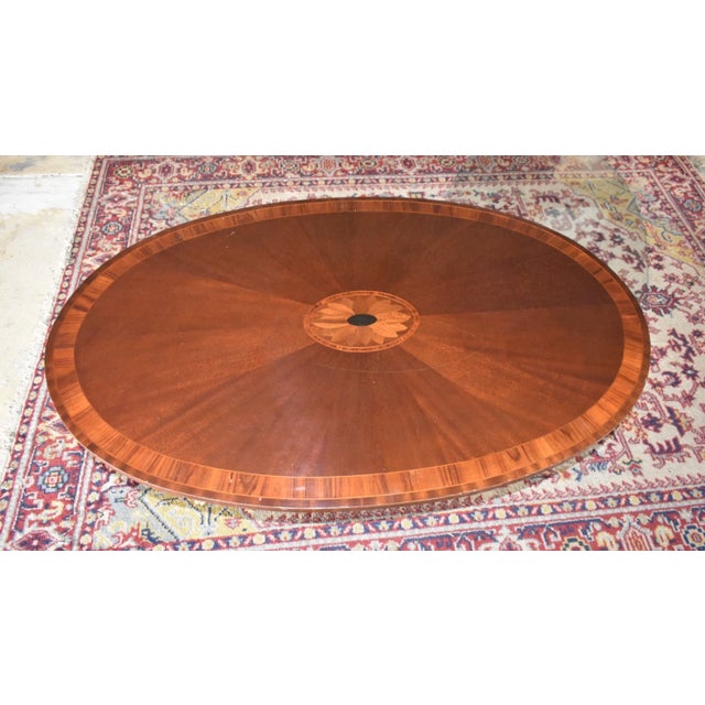 This stunning vintage oval coffee table dates to the 1950s and features beautiful craftsmanship throughout. The richly...