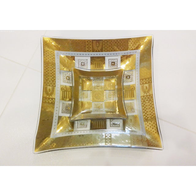 Stylish pair of Georges Briard mid-century transparent square glass bowls with a 22 karat gold Greek design. Marked...