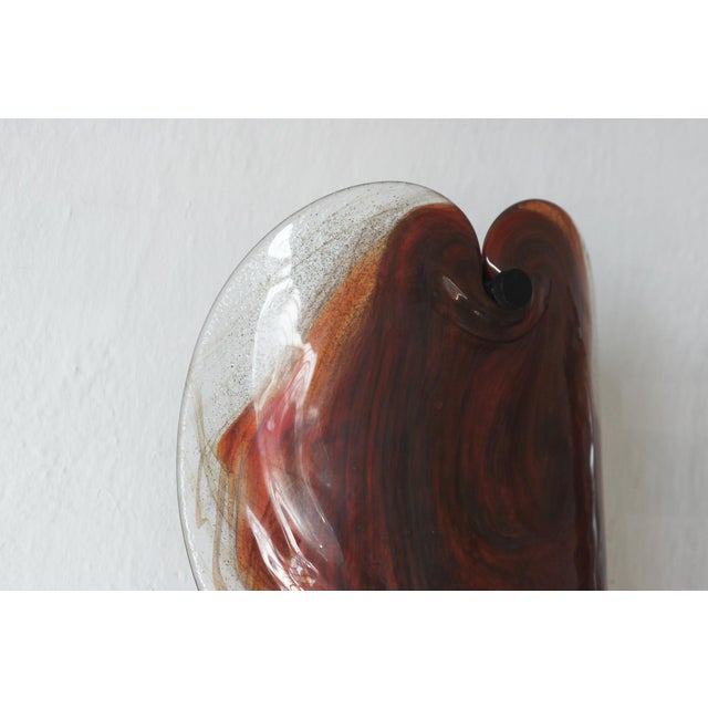 These two glass wall sconces, designed by Per Lütken for Holmegaard in the 1970s, are distinguished by their soft form and...