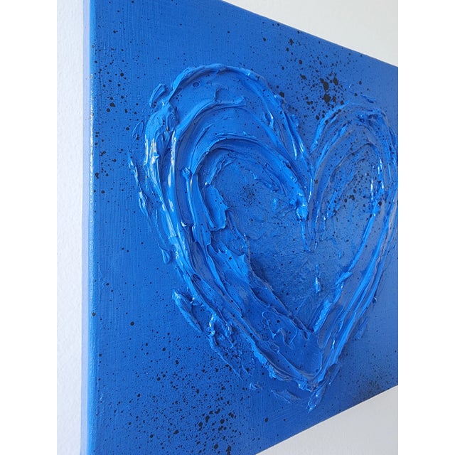 Blue textured heart with black splatter accents. A fun pop of color measuring 12"X12". *Please note, colors may vary per...
