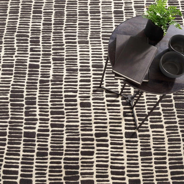 The rhythmical design of this luxurious, plush wool rug conjures surfaces of ancient hand-laid rock walls. The contrast...