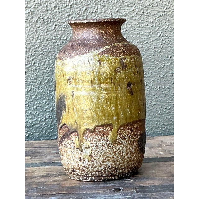 Embrace the unpretentious beauty of the natural world with this charming vintage studio pottery vase. Expertly hand-thrown...