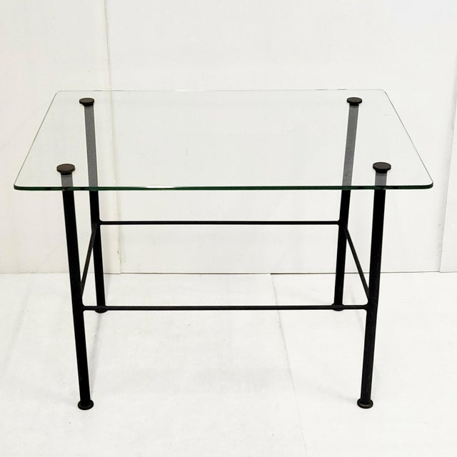 In fair condition, with the usual scratches on the glass top and slight oxidation of the black lacquered metal. Length 66...