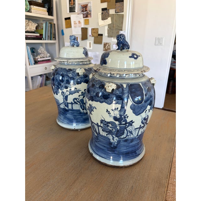 A charming pair of ginger jars finished in soft blue and antique white. Their classic rounded forms are accented with...