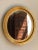 Offering a gorgeous mid-20th century giltwood oval wall mirror in the French Louis Philippe style. The bright gold gilt...