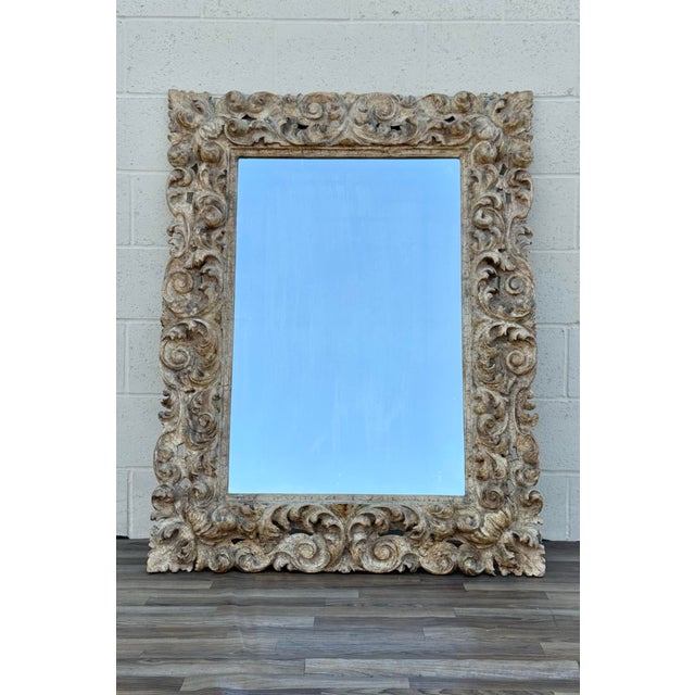 Beautiful antique carved wood wall mirror featuring an elaborate hand-carved frame with deep acanthus leaf and foliate...