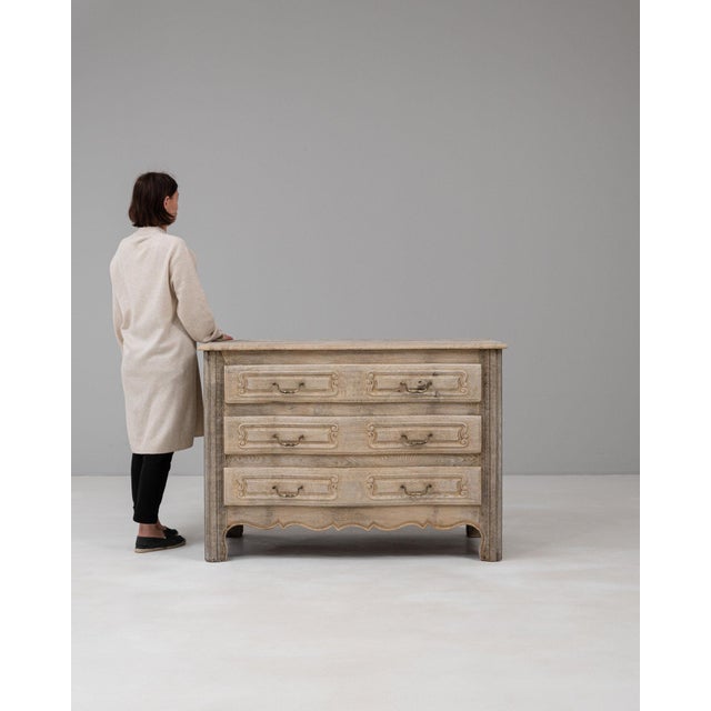 This piece presents as a chest of drawers, distinguished by natural oak, brass drop pull. Originating in France during...