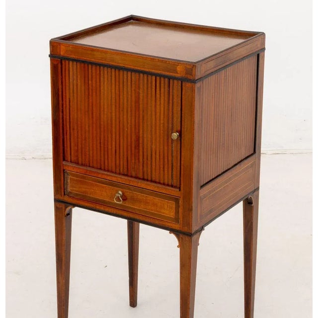 Hepplewhite Mahogany Bedside Table, late 18th century, with satinwood inlay and sliding tambour door cupboard above single...