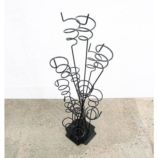 Sculptural and whimsical 10 bottle wine rack in solid iron. Heavy and well made. Unsigned example.
