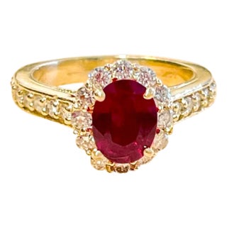 Oval 1.5 Carat Treated Ruby and 1.20 Carat Diamond 14 Karat Yellow Gold Ring For Sale