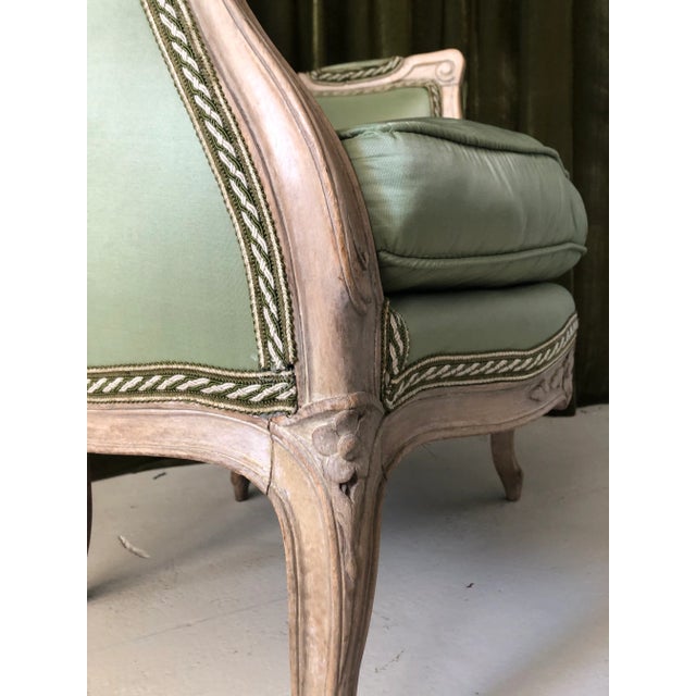 A petit French Louis XV period armchair or bergere (Circa 1760), recently upholstered in a green taffeta silk, with a...