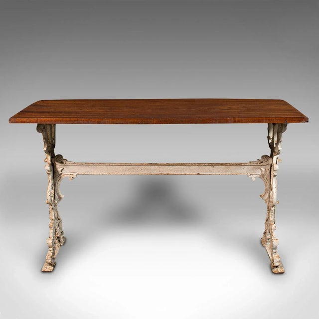 This is an antique orangery console table. An English, walnut and cast iron reception or side table, dating to the early...