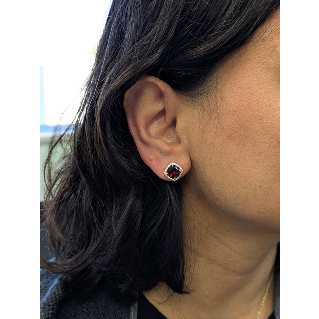 These elegant stud earrings feature rich 4.5 carat garnets, each measuring 8mm and glowing with deep red brilliance. Set...