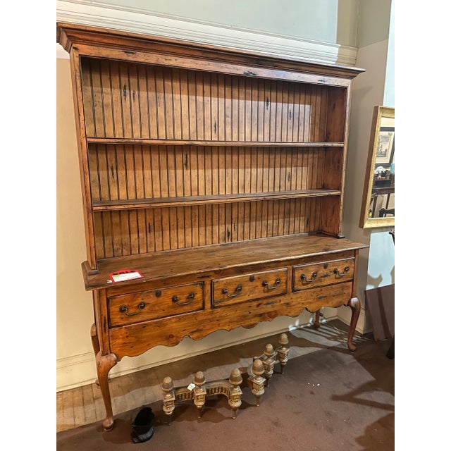 Knotty pine farmhouse style display sideboard; composed of two pieces: a top section with open stationary grooved display...