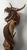 A commanding monumental hand-carved Asian dragon sculpture dramatically entwined around a naturally weathered tree trunk,...