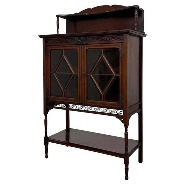 A beautifully crafted early 20th-century English Edwardian display cabinet, finely constructed in mahogany and...