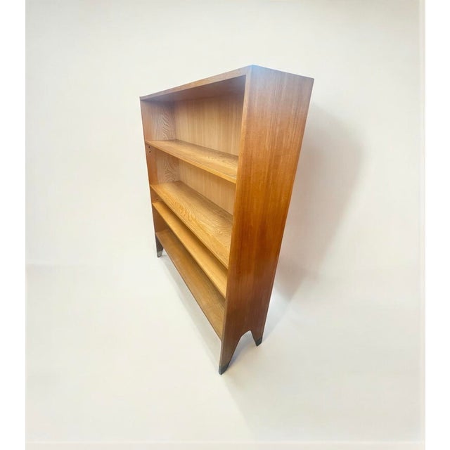 A beautifully crafted mid-century modern bookcase in Scandinavian design. Due to its conical shape (depth at the bottom...