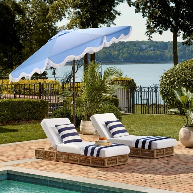 Elevate your outdoor oasis with the Torsa 9 ft crank umbrella in a delightful baby blue, featuring a sturdy brown pole....