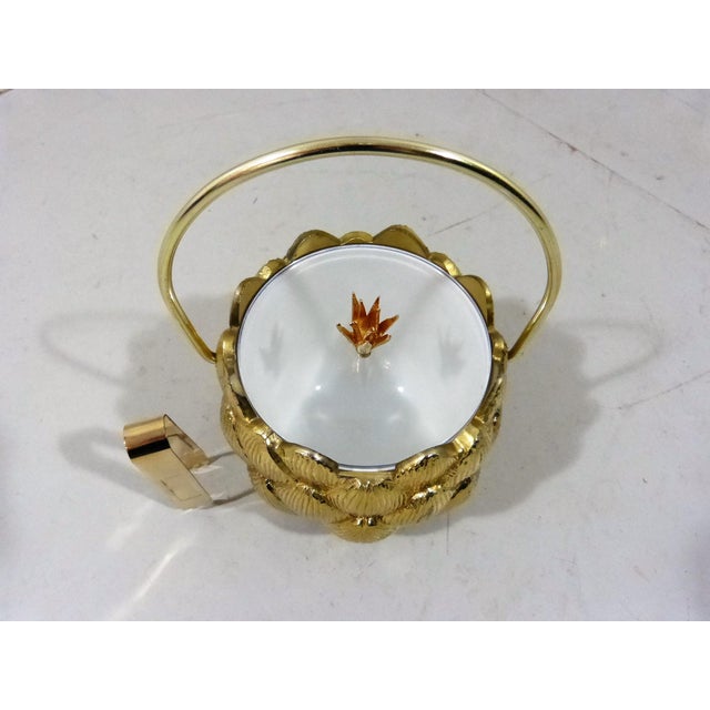 Ice bucket by Hans Turnwald for Freddotherm Switzerland (marked). Brass coloured artichoke shape, acrylic glass cover,...