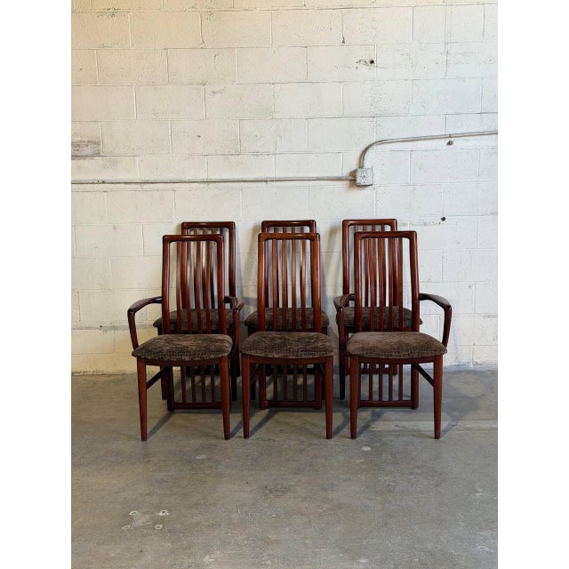 This set of six high-back dining chairs features an elegant slat-back design with supportive vertical spines. The...