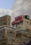 New Yorker by Neil Douglas | Oil on canvas Painting of a city skyline with a "New Yorker" sign. For Sale