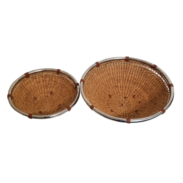 Vintage set of 2 large woven rope/rattan fiber baskets. These baskets feature chrome rings on top and base. Chrome rings...