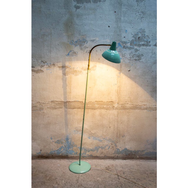 Floor lamp in enamelled iron and brass. Italian production 1950s European Plug (up to 250V).The wiring of this item may be...
