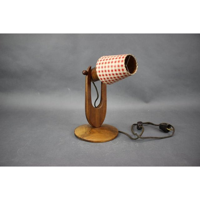 Elegant Mid-Century table lamp produced in Czechoslovakia during the 1970s. Crafted from solid wood, the lamp features a...