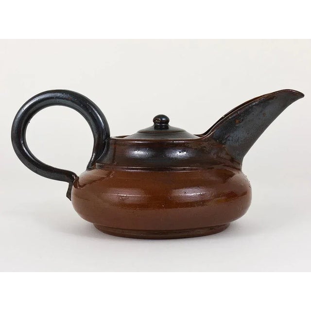 A beautiful Art Deco tea pot with lid, dated circa 1940, made of pottery / stoneware with lovely brown glaze, designed by...
