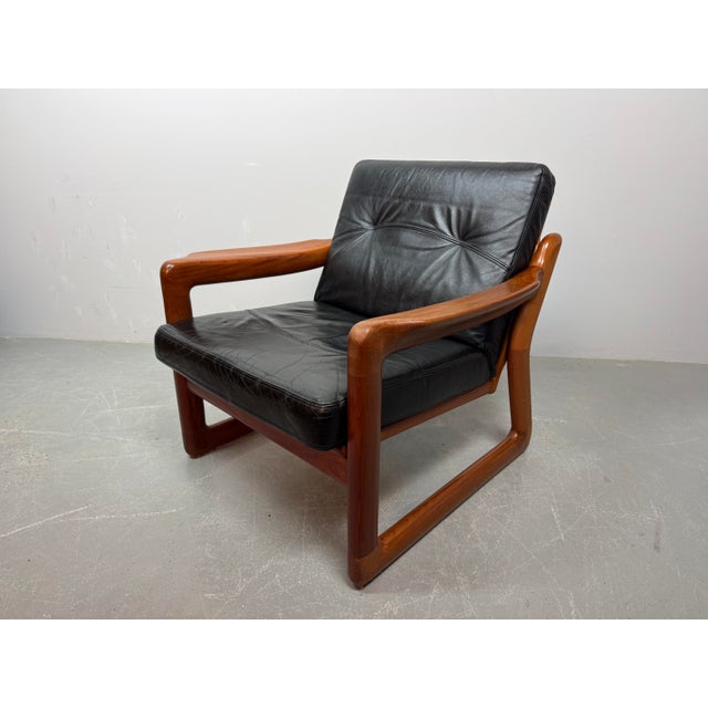 Set of 2 mid-century design komfort solid teak wooden lounge chairs with black leather cushions attributed to sven...