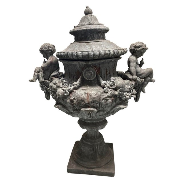This exceptional pair of antique Neoclassical style covered garden urns is masterfully crafted from heavy cast lead,...