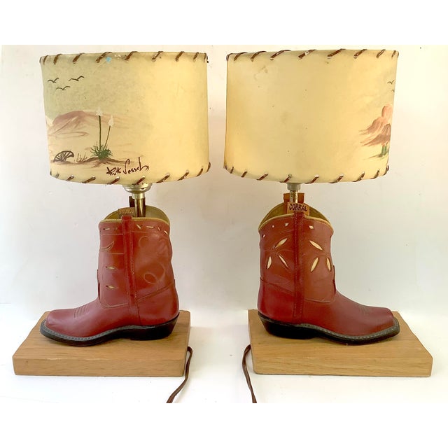 Circa 1950s children's red cowboy boot lamps mounted to wood bases, manufactured by Bradley Manufacturing Company of...