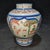 This charming Wucai (polychrome) style porcelain jar features a classic, rounded silhouette with a short neck. The body is...