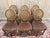 An elegant set of six Louis XVI style chairs, characterized by a caned medallion back and a generously padded, spring-...