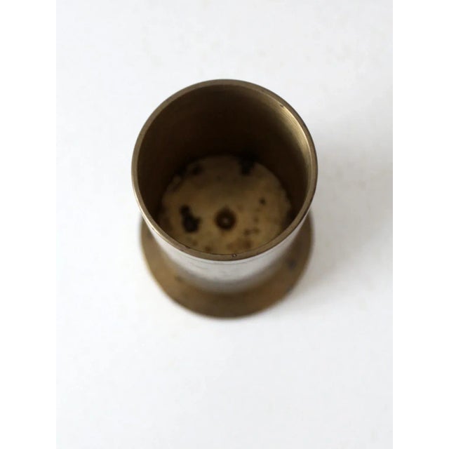 This is a vintage trench art piece. A brass shell casing shapes this clean-lined vase with pedestal base. Height: 6" ......