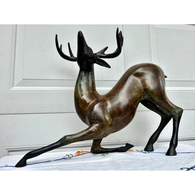 This graceful brass deer statue is beautifully colored. Standing almost 16 Inches high, it would make a great conversation...