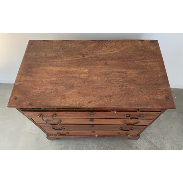 Antique American Colonial sideboard with brass hardware and bracket feet. The sideboard also has a slender felted drawer...