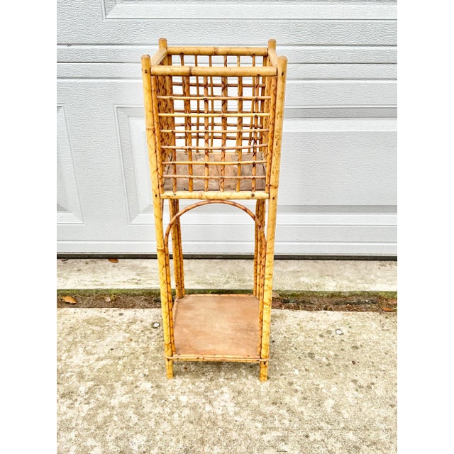 Lovely vintage plant stand. Made of tortoise bamboo. Has a place to hold a plant and a shelf on the bottom. Perfect to use...