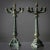 Pair of green-patinated bronze candlesticks with five arms and a central urn with a flame motif. The twisted shaft leads...