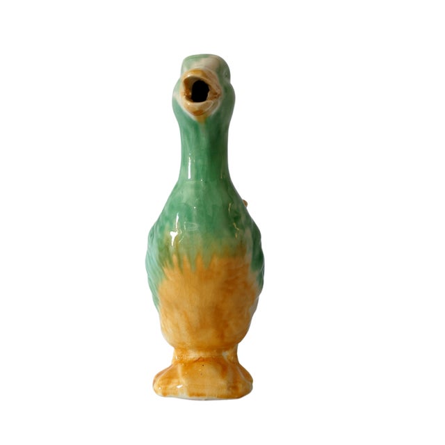 Charming vintage ceramic duck pitcher. Deep majolica glaze maintains it's bright colors. There is some crazing noted...