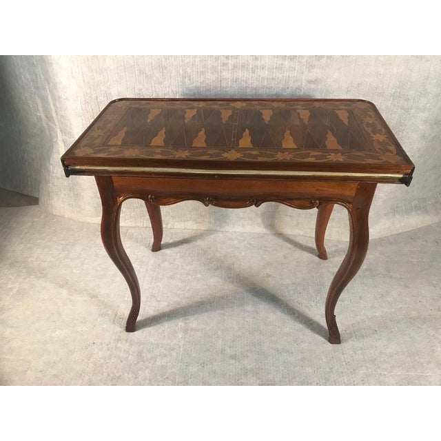This elegant 18th-century italian backgammon game table combines sophisticated marquetry with a clever, functional design....