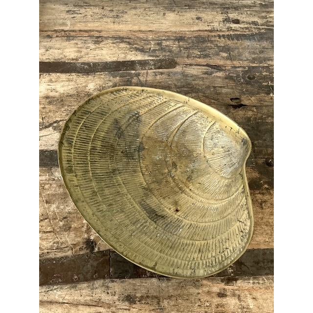 This striking vintage clamshell bowl is a quintessential example of Hollywood Regency design, perfectly blending coastal...
