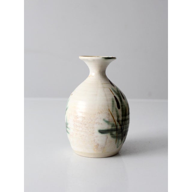 A vintage handmade studio pottery vase by Clouds of Folsom featuring a softly rounded silhouette and narrow neck that...