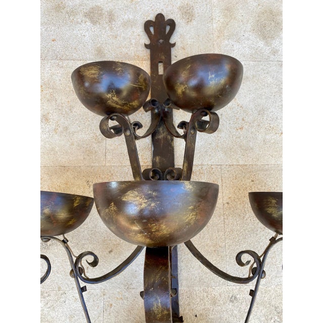 This elegant pair of Spanish wall sconces dates from the mid-20th century and showcases traditional hand-forged iron...